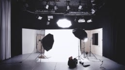 Video production studio with 3 softbox lights prepared for a business video production shoot.