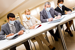Business people sitting with masks during the coronavirus pandemic.