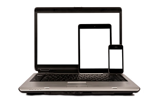 A computer, tablet, & mobile device that each benefit from mobile responsive designs.