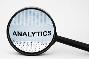 Magnifying glass zoomed in on the word "Analytics."